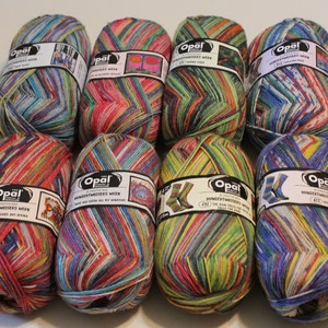 May include: Eight balls of colorful yarn with the brand name "Opal" and the text "Handarbeitswolle" on the label. The yarn is a mix of colors, including red, green, blue, yellow, and white.
