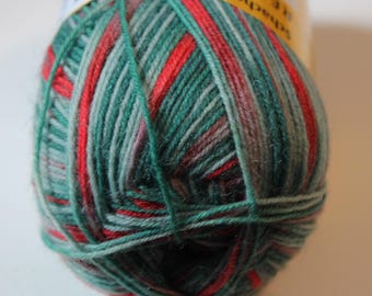 May include: A ball of Regia brand yarn in shades of green, red, and gray. The yarn is tightly wound, with visible strands of color creating a striped pattern. The label is partially visible, with text in German.