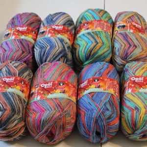 May include: Ten balls of colorful yarn with a label that reads "Opal Sockenwolle" in German. The yarn is a mix of blues, greens, reds, oranges, and yellows.