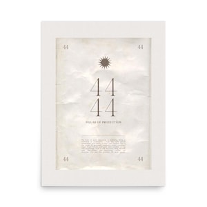 May include: A framed print with a white border. The print features the number 44 in a large font, a sunburst graphic, and the words "Pillar of Protection." The background has a vintage paper texture, and the corners of the print have the number 44.