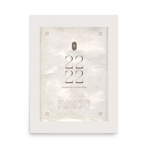 May include: A white framed print with the number "22" repeated four times, and the words "Harmonic Unfolding" below. The background has a vintage, textured appearance. The number "22" is also in each corner of the print.