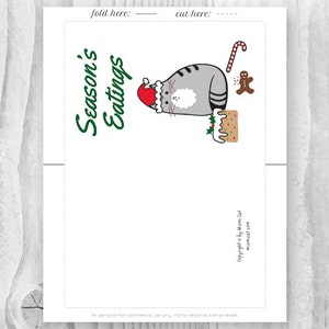May include: A printable Christmas card featuring a gray cat wearing a Santa hat and holding a gingerbread house. The text "Season's Eatings" is written in green cursive on the card.