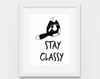 May include: Black and white cat illustration with green eyes, sitting on its hind legs with its paws raised. The cat has a white patch on its chest. The text "STAY CLASSY" is below the cat.