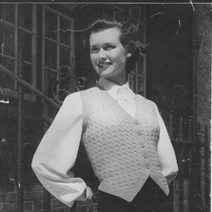 May include: Black and white photo of a woman wearing a knitted vest with buttons. The vest has a textured pattern. The photo is from a vintage knitting pattern. The pattern number is 936 and the price is 4d. The bust size is 34-36-42 inches.