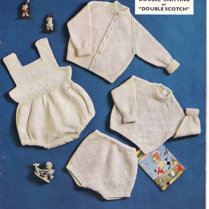 May include: A vintage knitting pattern booklet for a baby cardigan, a baby romper, and a pair of baby pants. The pattern is for 6 to 12 months old and is called "Double Knitting or "Double Scotch".