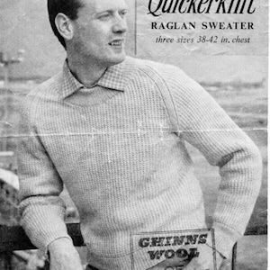 May include: A black and white photo of a man wearing a light gray sweater with a ribbed texture. The sweater has a round neckline and long sleeves. The man is standing in front of a wall with a sign that reads "Quickerknit Raglan Sweater three sizes 38-42 in. chest" and "GHINNS WOOL OF COURSE!"