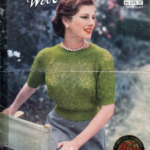 May include: A vintage knitting pattern featuring a woman wearing a green crocheted sweater with a pearl necklace. The pattern is for a 2-ply Roberta Wool sweater and is labeled "Robin No. 379 6d Copyright".