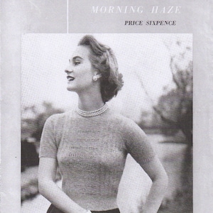 May include: Black and white photo of a woman wearing a knitted sweater with a delicate lace pattern. The sweater has short sleeves and a round neckline. The woman is wearing a pearl necklace and has her hair styled in a short, neat updo. The photo is from a vintage knitting pattern leaflet.