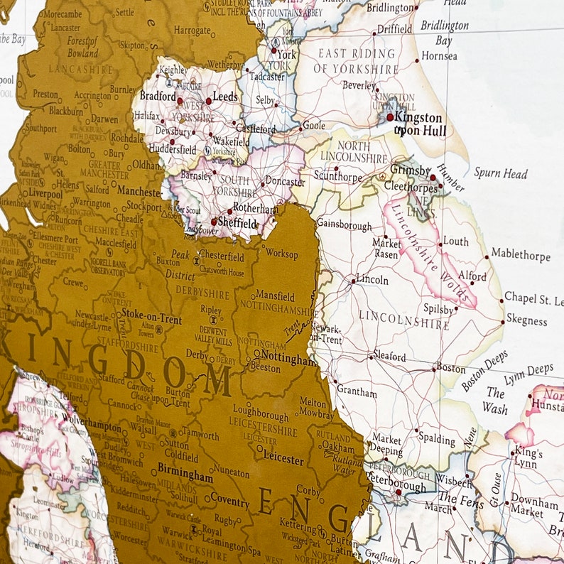 May include: A vintage-style map of England with county borders highlighted in gold. The map shows major cities, towns, and rivers. The map is printed on a cream-colored background.