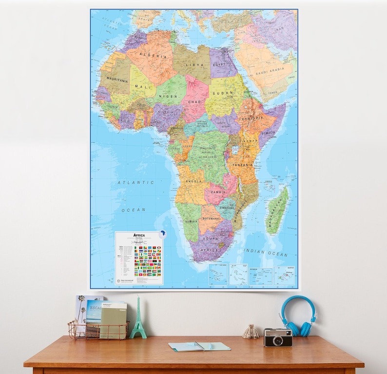 May include: A large, colourful map of Africa, showing countries with clear borders and names. The map includes oceans and a smaller inset with flags. The map is mounted on a white wall.