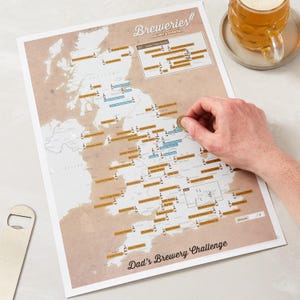 May include: A map of the United Kingdom with a list of breweries and a challenge to visit them. The map is printed on a beige background with brown text and brown and blue icons. The text at the bottom of the map reads "Dad's Brewery Challenge".