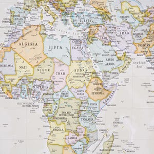 May include: A detailed map of the world with a focus on Africa and the Middle East. The map is printed on a white background with colored borders for each country. The map includes country names, major cities, and geographic features.