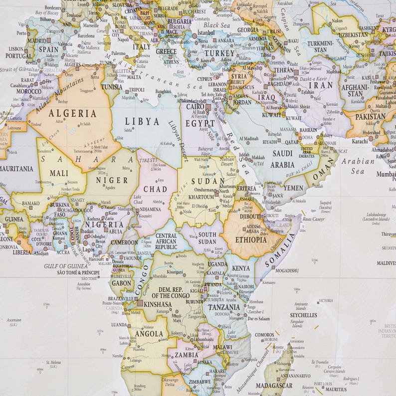 May include: A detailed map of the world with a focus on Africa and the Middle East. The map is printed on a white background with colored borders for each country. The map includes country names, major cities, and geographic features.