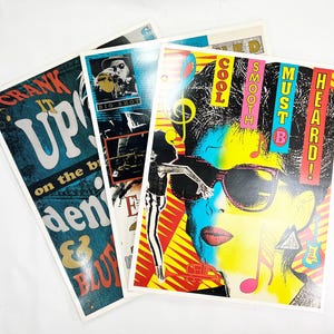 May include: Three rectangular posters with vibrant graphic designs. One features a person wearing sunglasses with the text COOL SMOOTH MUST B HEARD! Another displays the text CRANK IT UP on the break denim & blues. The third shows a person labeled BIG SHOT.