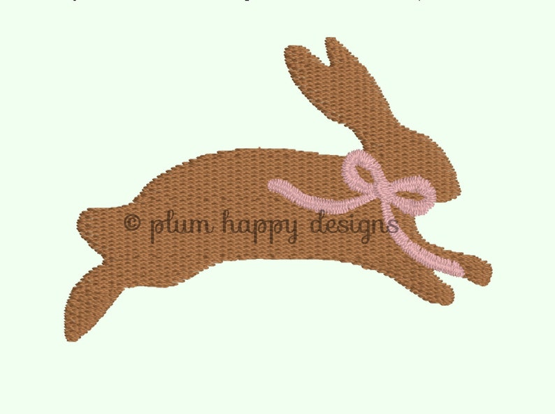 May include: A brown bunny rabbit with a pink ribbon around its neck. The bunny is jumping in the air.