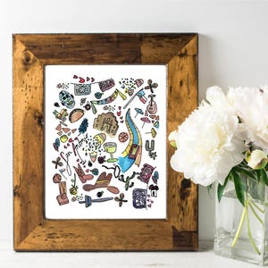 May include: A framed print with a watercolor illustration of San Antonio landmarks and icons. The artwork includes a mission, a guitar, a cowboy hat, and the text "San Antonio". The frame is made of rustic wood.