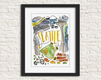 Könnte beinhalten: Ein gerahmter Aquarelldruck mit Sehenswürdigkeiten von Seattle. Das Kunstwerk zeigt die Space Needle, die Public Library und das Public Market Center, mit dem Stadtnamen in Gelb. Der Druck hat einen schwarzen Rahmen und wird vor einer weißen Backsteinmauer gezeigt.