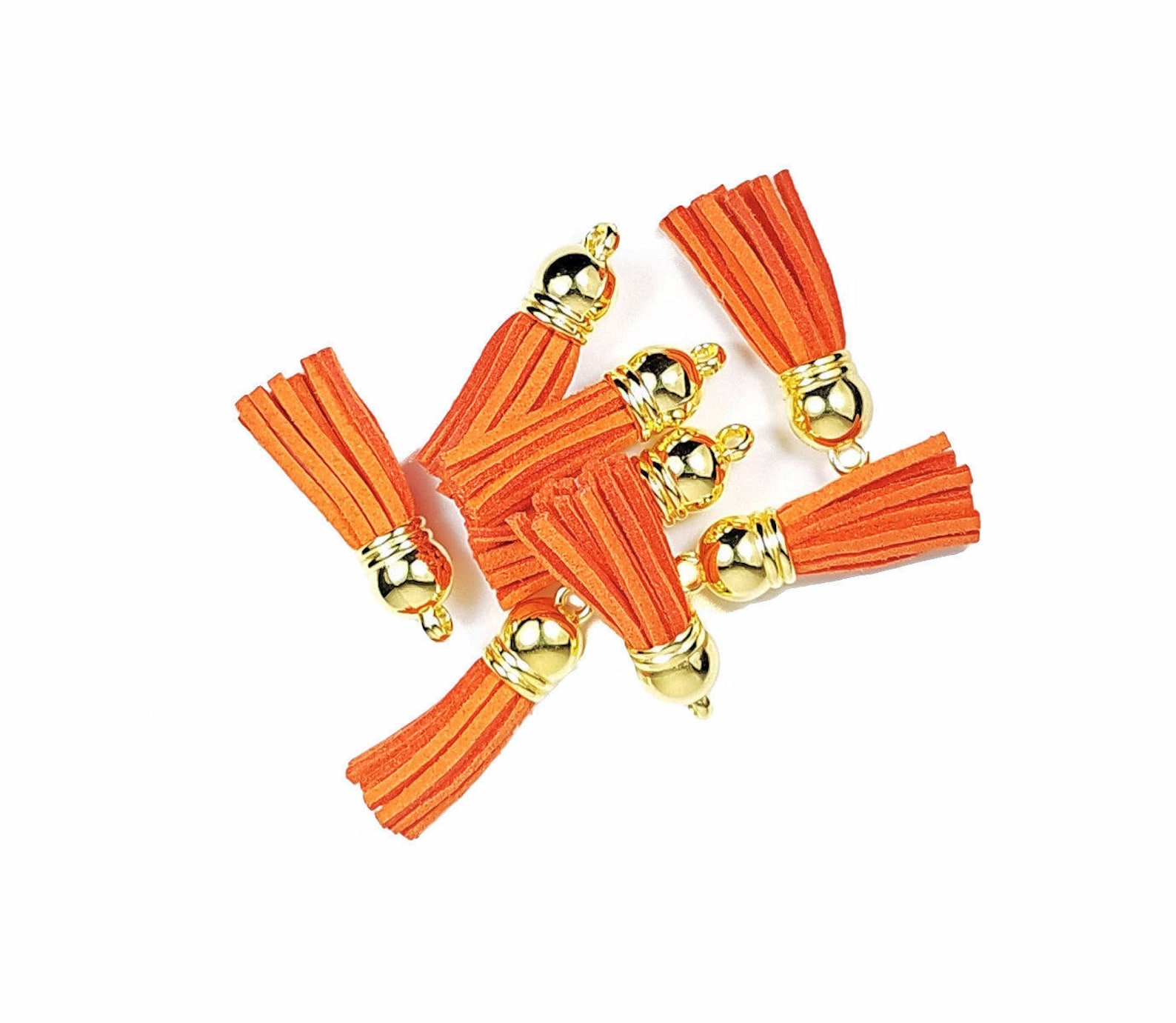 Pretty orange mini tassels with gold caps.