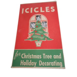 May include: A white ceramic mug with a black handle and the text "But First, Coffee" in a bold, black font. The mug is sitting on a wooden surface. The mug is approximately 4 inches tall.