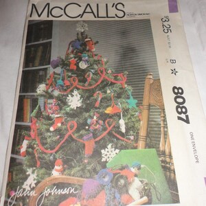 May include: A vintage McCall's sewing pattern for a Christmas tree with crocheted ornaments. The pattern number is B 8087 and the price is $3.25. The pattern is signed "Jatin Johnson".