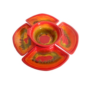 May include: A red and yellow ceramic serving dish with four sections and a central bowl. The dish has a swirl pattern.