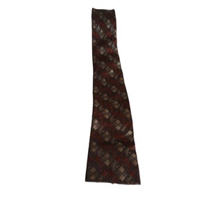 May include: A brown and gold patterned tie with a diamond pattern.