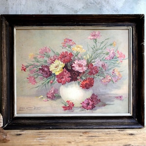 May include: A framed painting depicting a bouquet of pink, red, and yellow carnations arranged in a white vase. The painting is signed "John Walter Dixon".