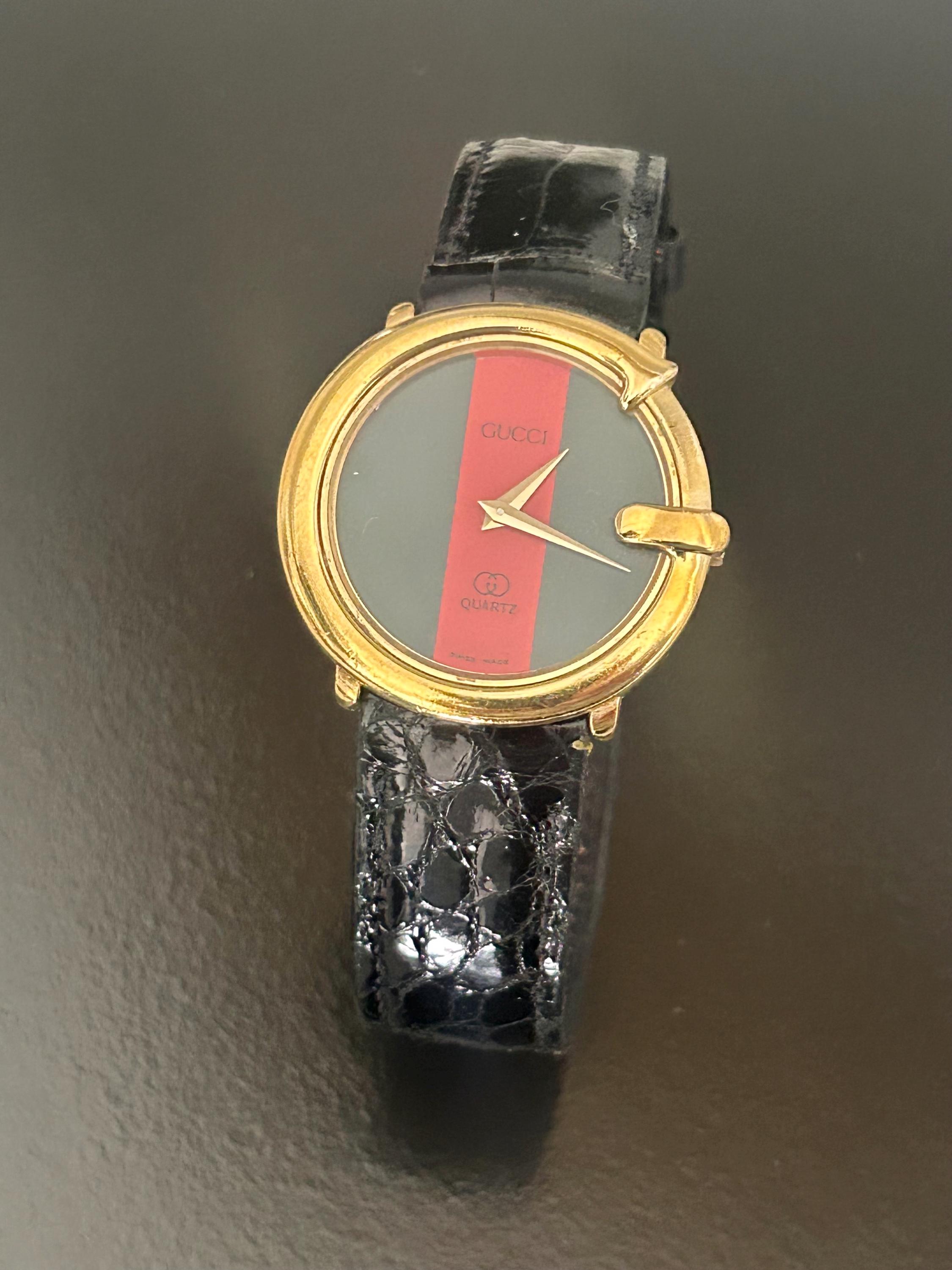Gucci Green & Red Stripe Gold-Tone Round Watch Gucci is back with an icon, the house revives its famed 80s  main image 2