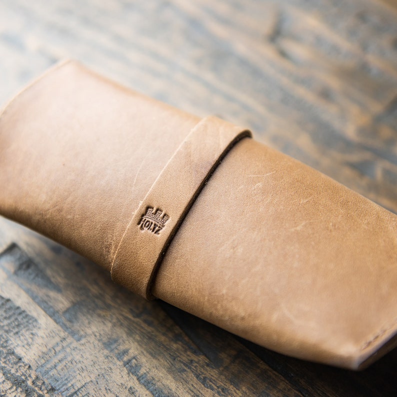 Tan full grain leather sunglasses case. Keep your shades safe in this hand made sunglasses case that can be personalized with your initials. There is a brass knob to latch the case shut and keep your eyewear safe.