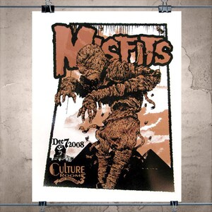 May include: A poster featuring the band "Misfits" with a mummy graphic in brown and black. The poster includes the date "Dec 7 2008" and the venue "Culture Room" in Fort Lauderdale.
