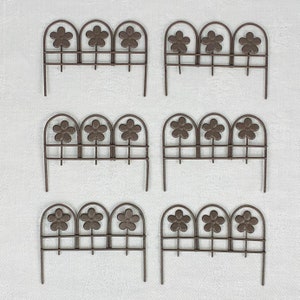 May include: Set of six black metal garden fence panels with flower cutouts. Each panel has three flower shapes.