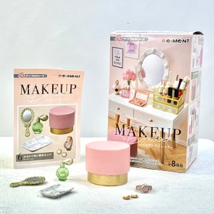 May include: A pink and gold makeup vanity set with a mirror, stool, and various makeup accessories. The set is part of the Re-Ment Makeup Dresser collection.