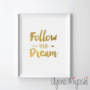 Può includere: Una stampa incorniciata bianca con un design in foglia d'oro che dice "Follow Your Dream" con una freccia che punta a destra. Il nome dell'artista, "Uyeno Miyoshi", è scritto in corsivo nella parte inferiore della stampa.