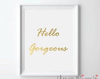 May include: White framed print with gold lettering that reads "Hello Gorgeous" with the artist's name "Uyeno Miyoshi" in cursive at the bottom.