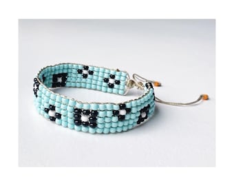 Glass beaded loom bracelet // aqua blue with black flowers pattern (adjustable)