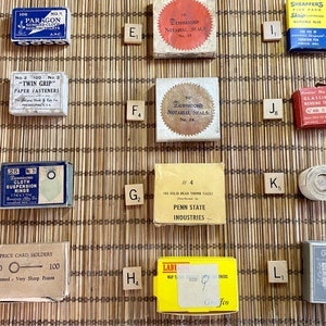 May include: Assortment of vintage boxes and labels, including "Paragon Gummed Cloth Reinforcements", "Twin Grip Paper Fasteners", "Penn State Industries", "Deminico Notarial Seals", "Sheaffers Skrip Washable Blue Ink", "Glassine Mending Tape", "Cloth Suspension Rings", "Price Card Holders", "Label Gummed Map Tabs", and "Guild".