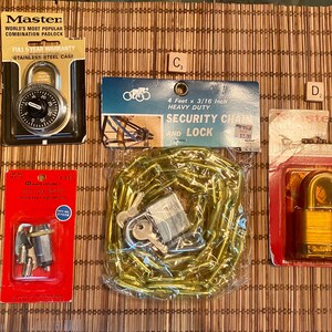May include: Assortment of four different types of locks and keys, including a combination padlock, a chain and lock, a key switch, and a padlock with a key. The locks are all silver or gold in color and are packaged in plastic bags or boxes.