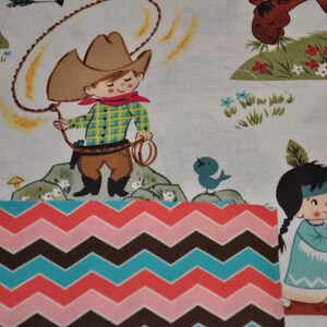 May include: A colorful fabric with a chevron pattern in pink, brown, and blue. The fabric features a cartoon cowboy with a lasso and a Native American girl with a feather headdress.