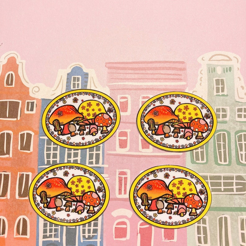May include: Four yellow and orange mushroom-shaped coasters with a floral design. Each coaster features a group of three mushrooms with red and white polka dots.