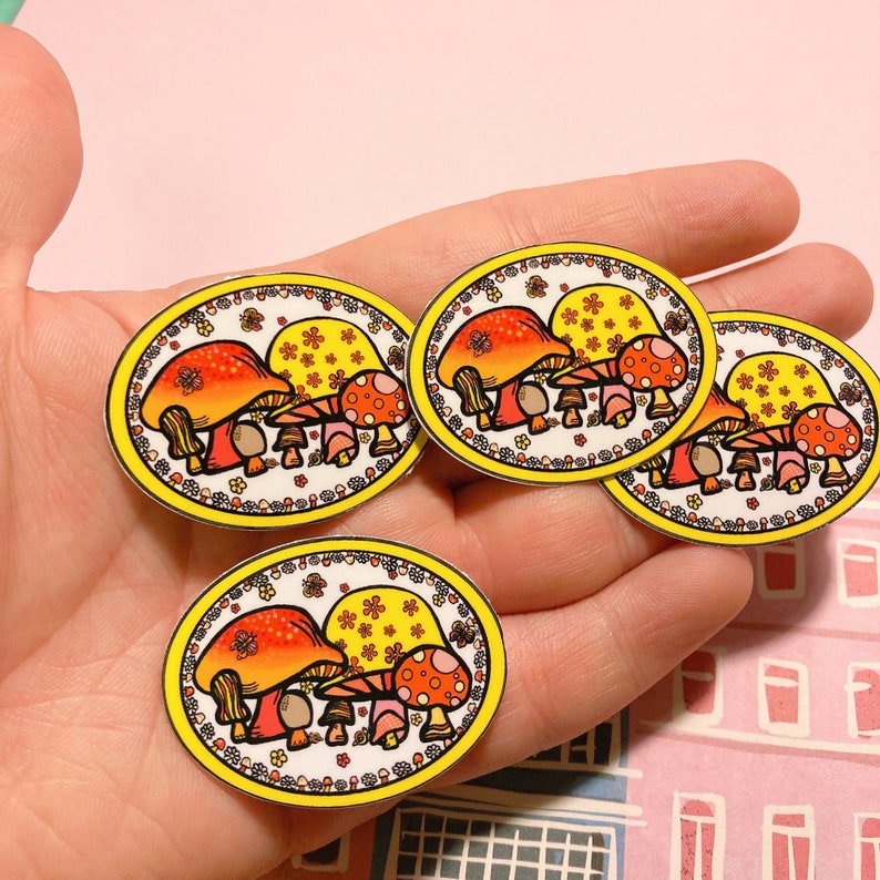 May include: Four colorful mushroom stickers with yellow, orange, and red accents. The mushrooms are surrounded by a yellow border with white flowers and green leaves.