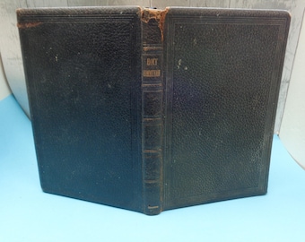 May include: A black leather-bound book with the title "Holy Communion" embossed on the spine.