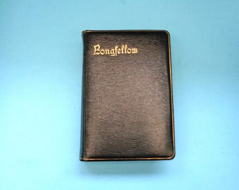 May include: A black leather-bound book with gold lettering that reads "Longfellow".
