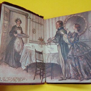 May include: Open book with illustrations of a Victorian-era scene. The left page shows a woman in a maid's uniform carrying a tray. The right page depicts a man and woman in formal attire. Text on the pages reads "On Friendship".