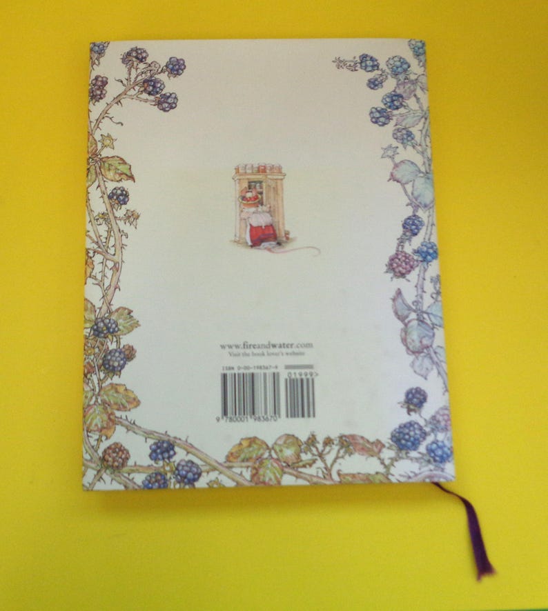 May include: A book cover with a whimsical illustration. The cover features a drawing of a mouse in a red dress, framed by a border of blackberries and leaves. The website www.fireandwater.com is visible.