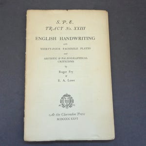 May include: A cream-colored softcover book titled S.P.E. TRACT No. XXIII ENGLISH HANDWRITING with THIRTY-FOUR FACSIMILE PLATES and ARTISTIC & PALEOGRAPHICAL CRITICISMS by Roger Fry & E. A. Lowe, published at the Clarendon Press in M DCCCC XXVI.