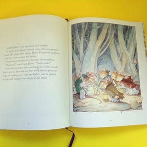 May include: An open book with a colorful illustration of mice in a forest setting. The illustration features several mice gathered around a lantern, with a backdrop of tall trees. Text is visible on the left page.