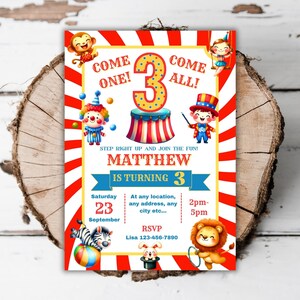 May include: A colorful circus-themed birthday invitation for a child turning three. The invitation features a red and white striped tent, a clown, a monkey, a lion, a zebra, and a magician. The text on the invitation reads "Come One! Come All! Matthew is turning 3. Saturday, September 23, 2pm-5pm. At any location, any address, any city etc... RSVP Lisa 123-456-7890."
