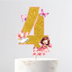 May include: Gold glitter number four cake topper with a pink outline. The number is decorated with two fairies, a frog, and flowers. The fairies are wearing pink dresses and have brown hair. The frog is green and has a pink flower on its head.