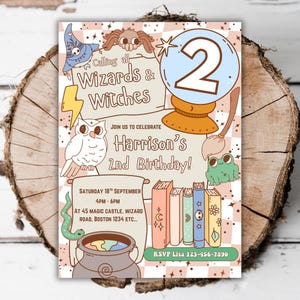 May include: A whimsical invitation for a second birthday party. The design features illustrations of a wizard's hat, owl, spider, crystal ball, books, and a cauldron. The text reads "Calling all Wizards & Witches" and "Harrison's 2nd Birthday!"