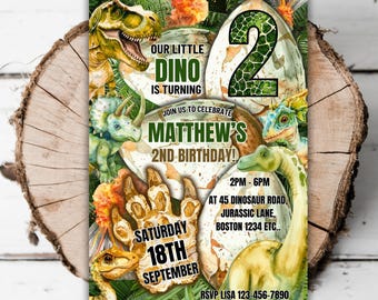 May include: A green and brown dinosaur-themed birthday invitation for a 2-year-old boy named Matthew. The invitation features a dinosaur egg with the number 2 on it, a dinosaur footprint, and various dinosaurs. The text on the invitation reads "Our Little Dino is Turning 2, Join Us to Celebrate Matthew's 2nd Birthday! Saturday 18th September, 2PM-6PM at 45 Dinosaur Road, Jurassic Lane, Boston 1234 ETC., RSVP Lisa 123-456-7890."